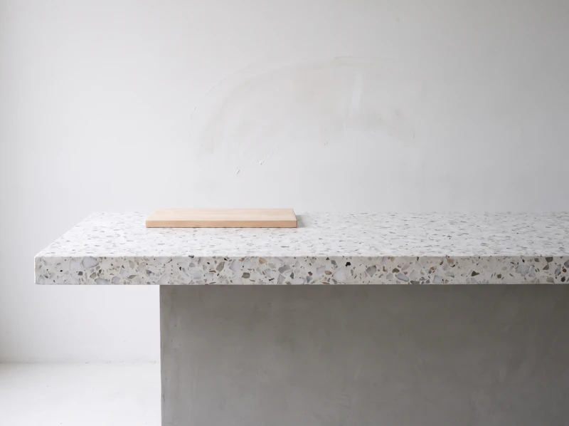 A counter cut from one slab of white marble chip terrazzo, honed edge