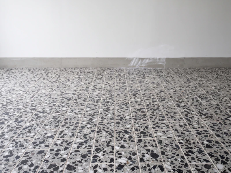 A lobby floor laid in black chip and white spar tiles in a brick bond
