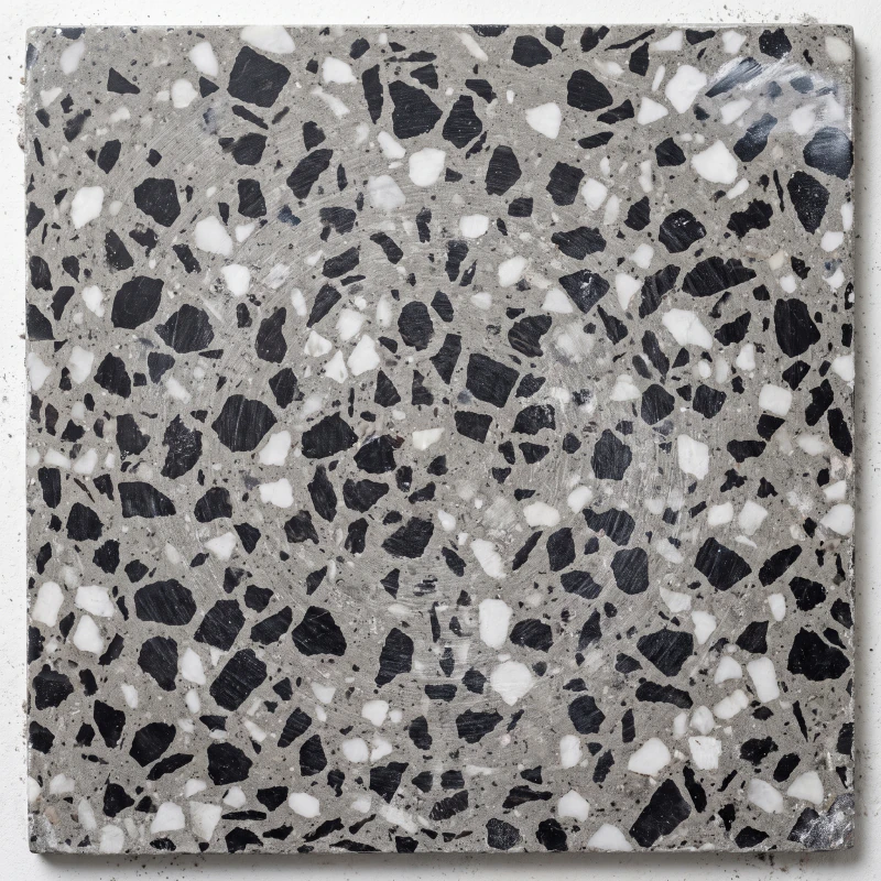 Black chip with white spar in a grey cement