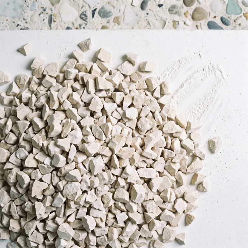 Pale oat coloured stone chip heaped on a chalk surface