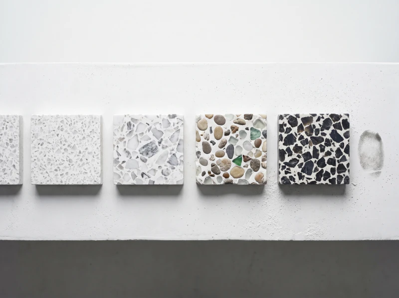 Cut sample pieces laid in a row along a chalk bench, fine chip to coarse