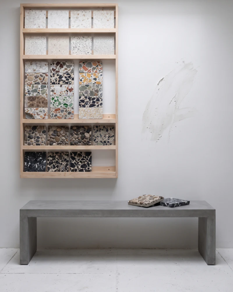 The sample room, a rack of cut terrazzo pieces sorted by chip above a cement bench