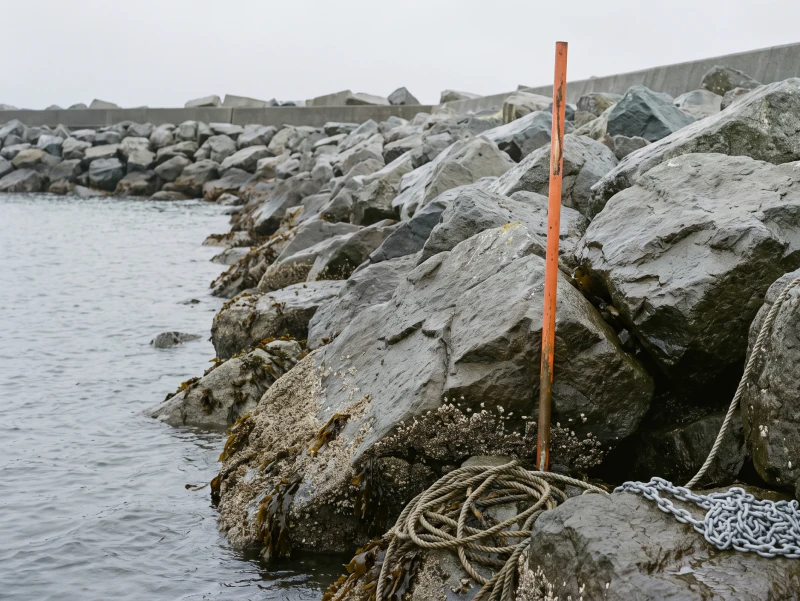 Rock armour reset along the toe of a revetment