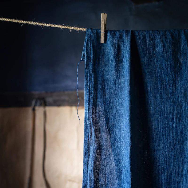Finished blue linen pegged on the hemp line, the weave showing